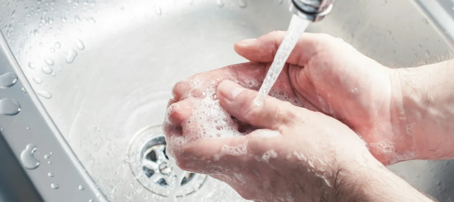 Person using the sink faucet
