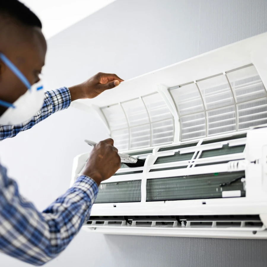 Professional cleaning an AC unit