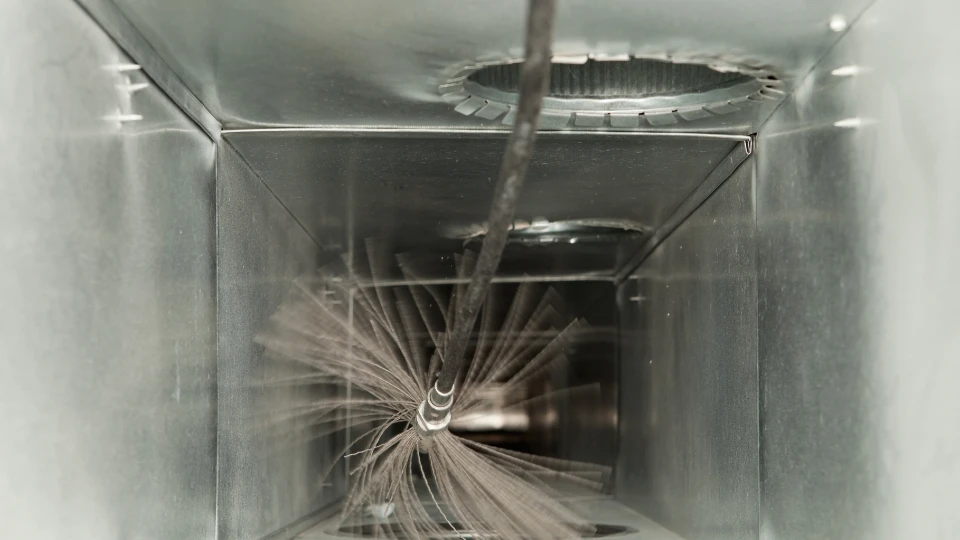 cleaning an air duct with a tool