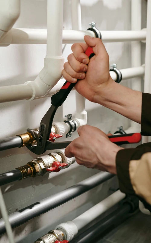 technician fixing a water heater in Edmond
