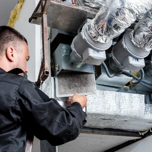 technician inspecting air ducts