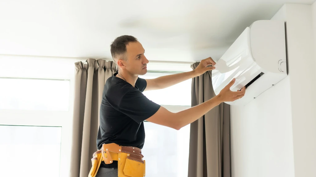 man cleaning an AC unit