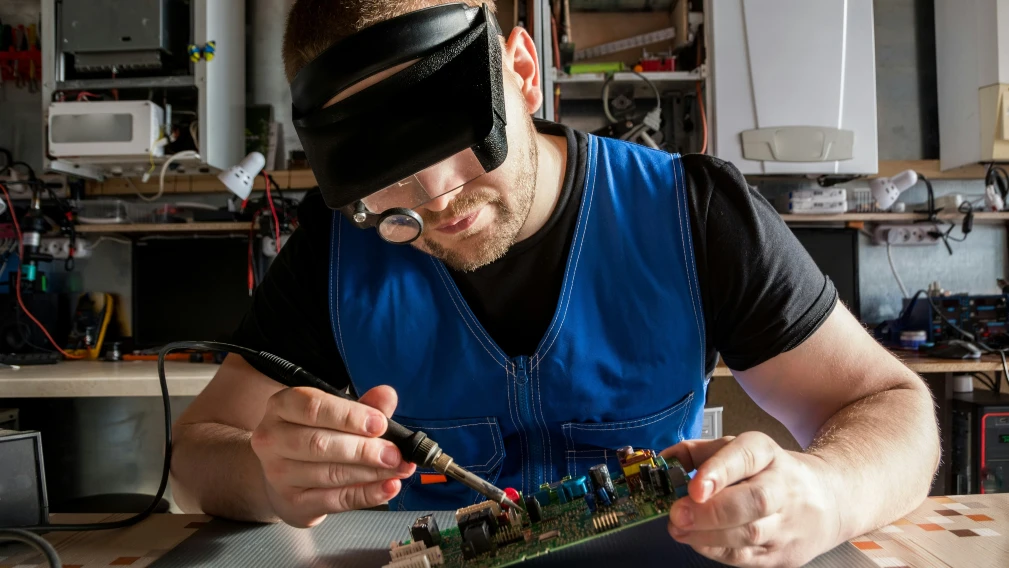 engineer repairs electronic board for gas and electric heating boilers