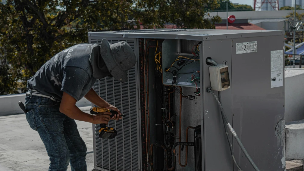 repairman repairing a air conditioner
