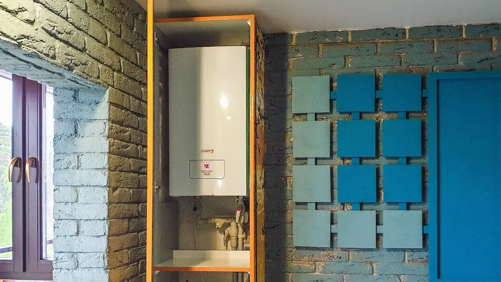 Compact wall-mounted water heater installed inside a home